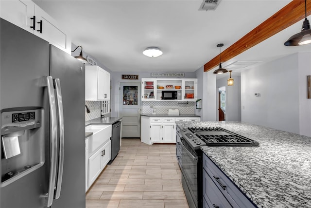 kitchen with hanging light fixtures, stainless steel appliances, decorative backsplash, light stone countertops, and white cabinets