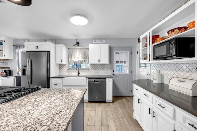 kitchen with sink, stainless steel appliances, and white cabinets