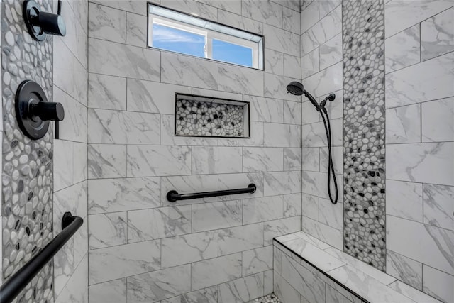 bathroom featuring a tile shower