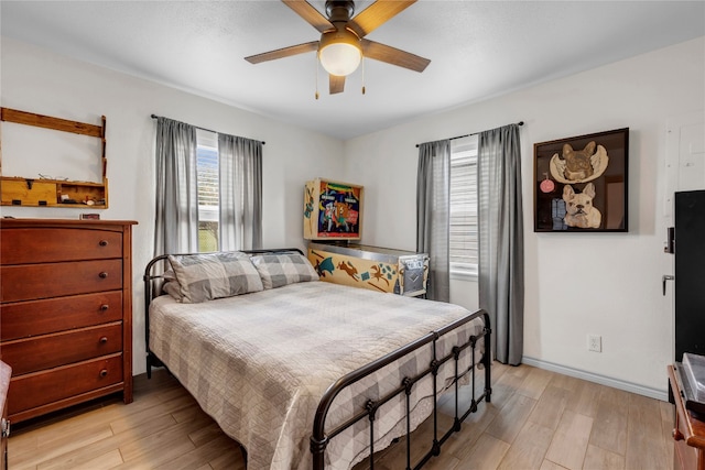 bedroom with light wood-type flooring and ceiling fan