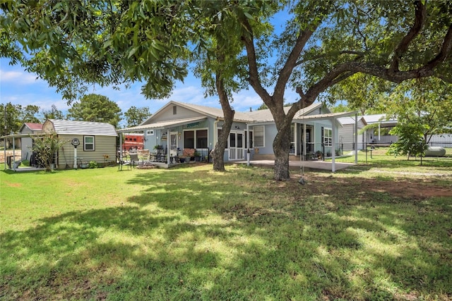 rear view of house featuring a lawn