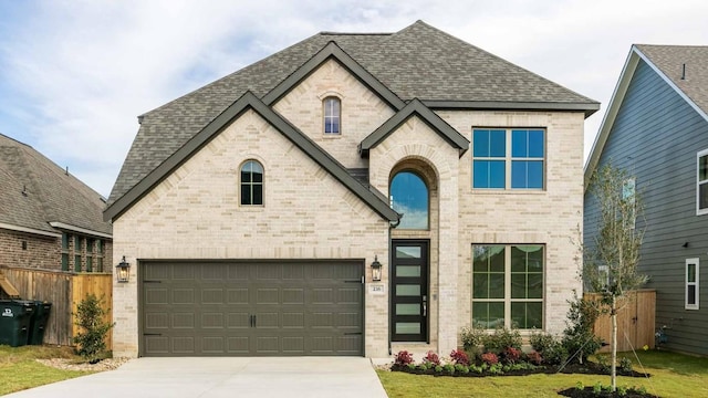 view of front of property featuring a garage and a front lawn