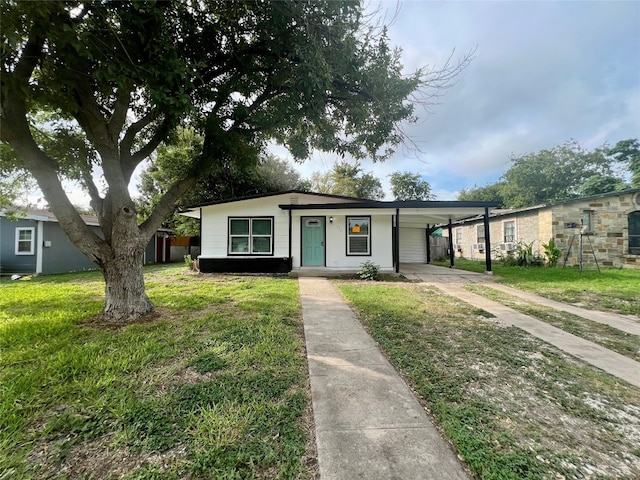 ranch-style home with a carport and a front yard