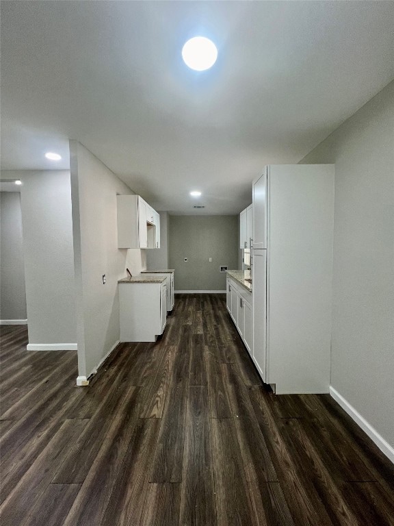 kitchen with white cabinetry and dark hardwood / wood-style floors