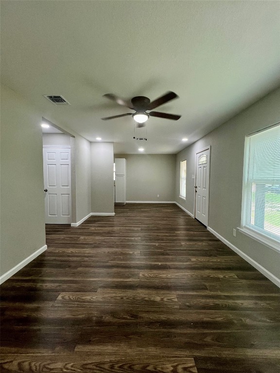 interior space with ceiling fan and dark hardwood / wood-style floors