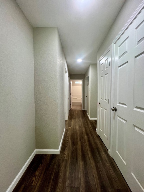 corridor with dark wood-type flooring