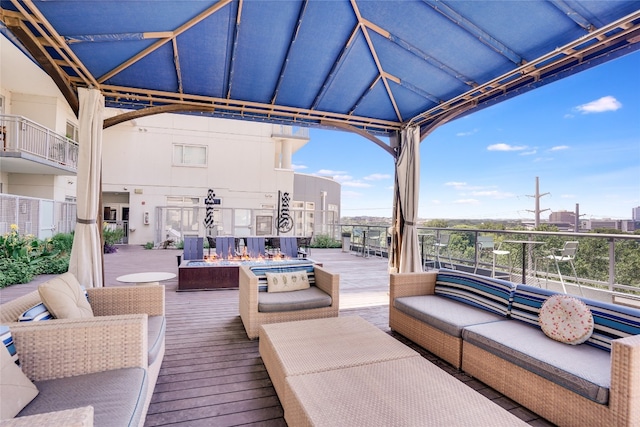 wooden terrace with outdoor lounge area and a gazebo