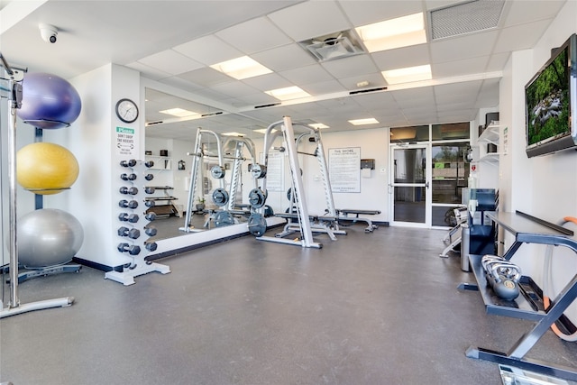 exercise room with a drop ceiling