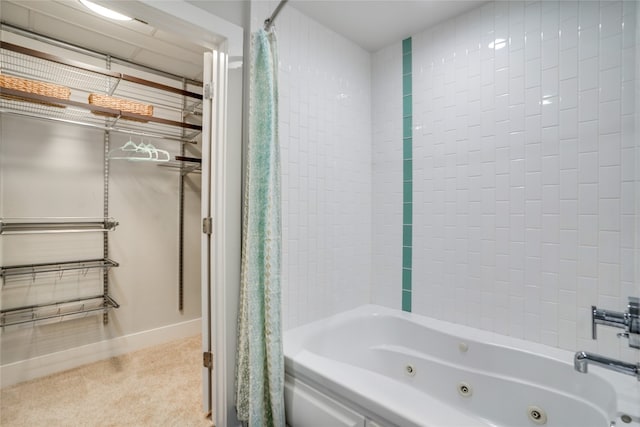 full bath featuring baseboards and a combined bath / shower with jetted tub