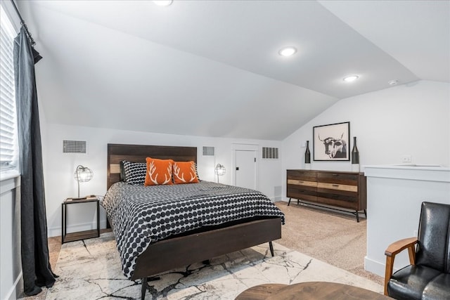 carpeted bedroom with lofted ceiling and multiple windows