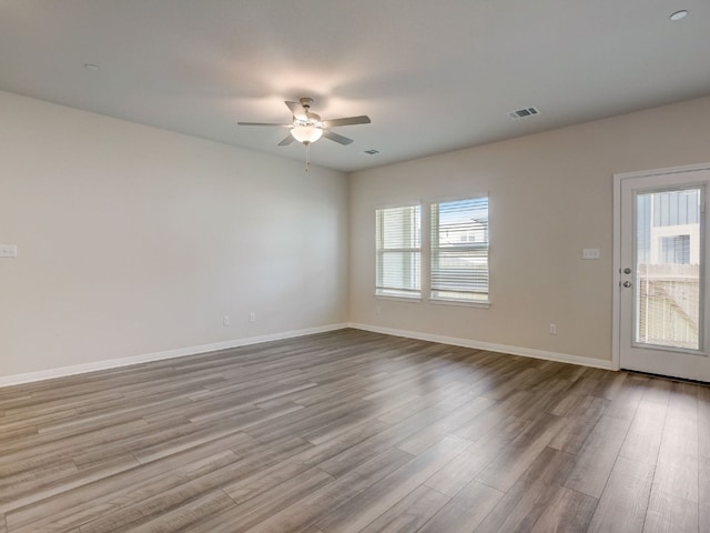 spare room featuring light wood-type flooring and ceiling fan