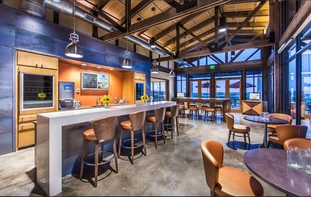 bar featuring pendant lighting, wood ceiling, high vaulted ceiling, and beamed ceiling