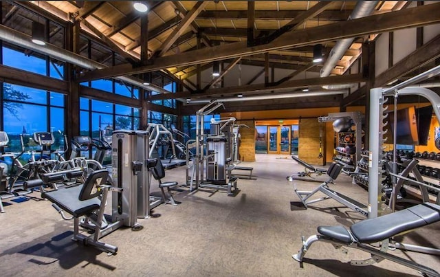 gym with high vaulted ceiling and wooden ceiling