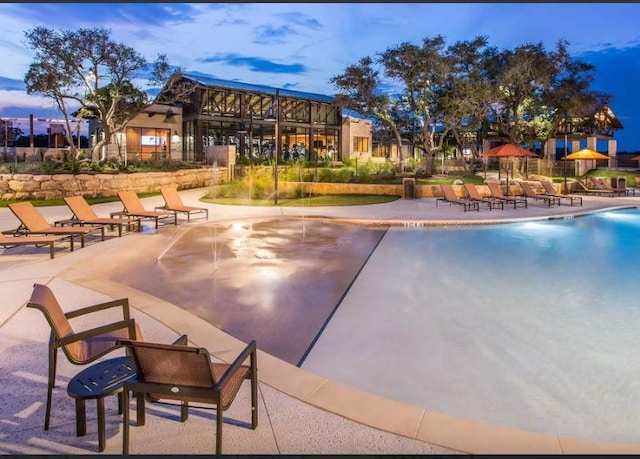 view of pool at dusk