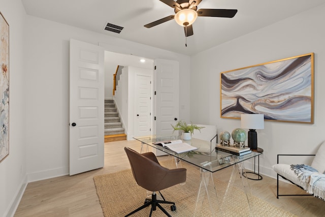 office space featuring ceiling fan and light hardwood / wood-style flooring