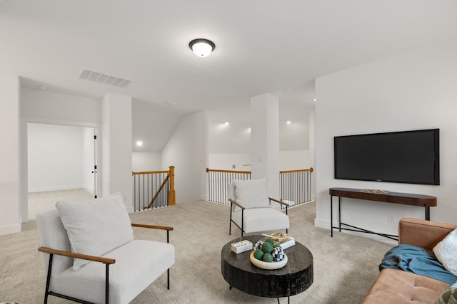 carpeted living room with vaulted ceiling