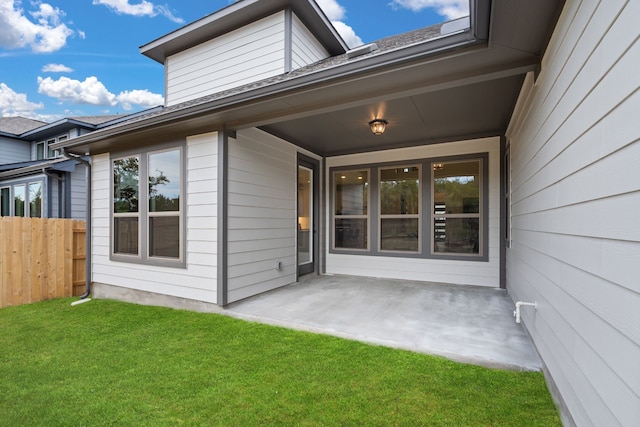 doorway to property featuring a yard and a patio