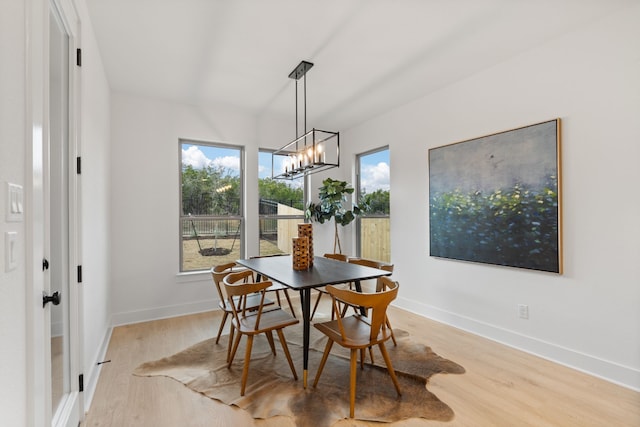 dining room with an inviting chandelier and light hardwood / wood-style floors