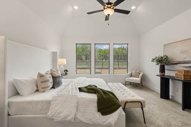 bedroom featuring vaulted ceiling, light colored carpet, and ceiling fan