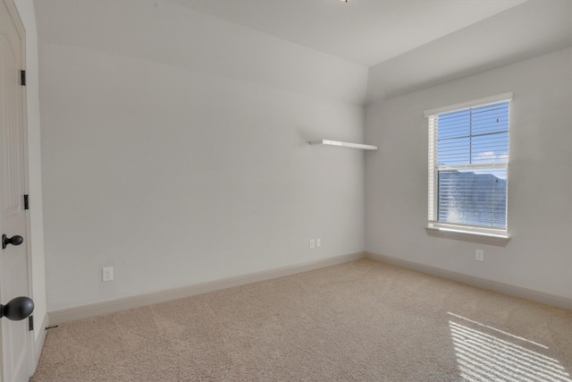 spare room featuring light colored carpet