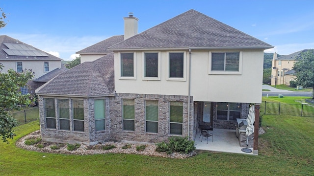 rear view of property featuring a yard and a patio area