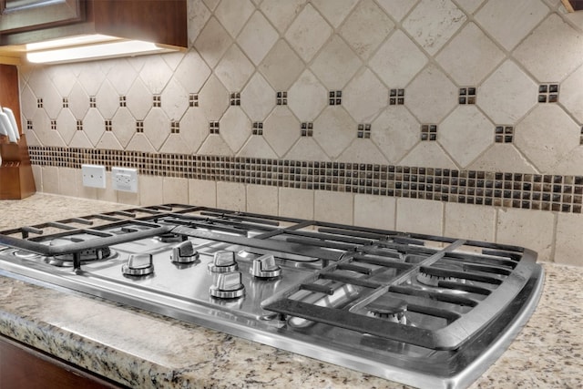 room details featuring stainless steel gas stovetop and backsplash