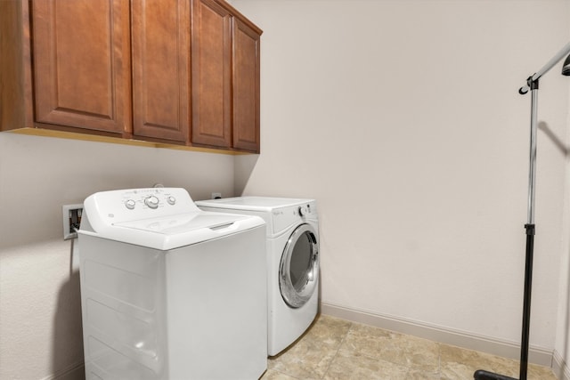 laundry room with cabinets and washing machine and dryer