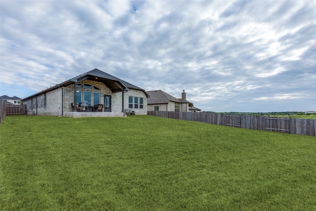 back of house featuring a yard