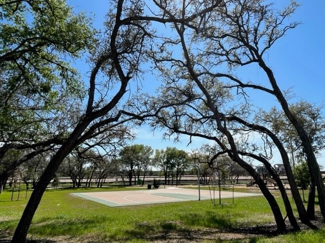 view of basketball court featuring a yard