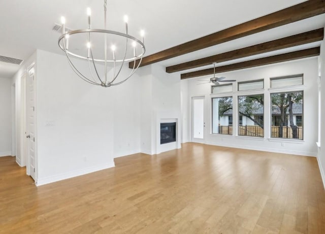 unfurnished living room featuring beam ceiling, ceiling fan with notable chandelier, and light hardwood / wood-style floors