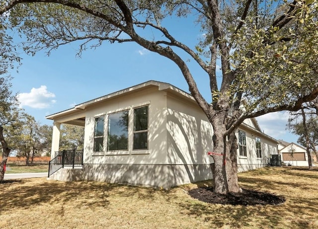 view of side of property with a lawn