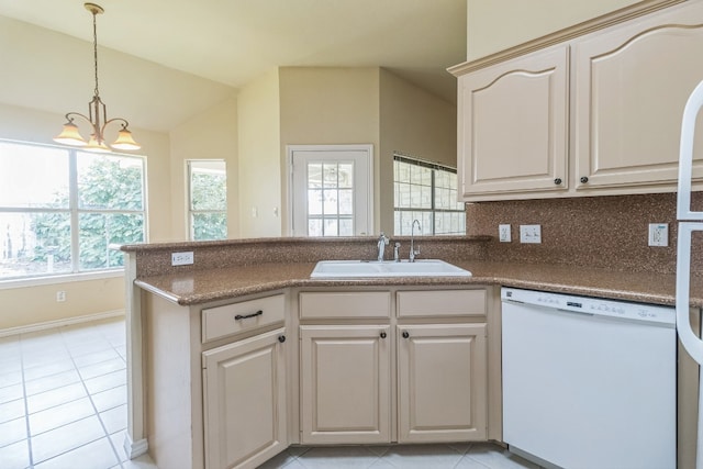 kitchen with light tile patterned flooring, vaulted ceiling, dishwasher, sink, and a chandelier