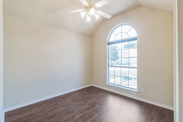 spare room with ceiling fan, vaulted ceiling, and dark wood-type flooring