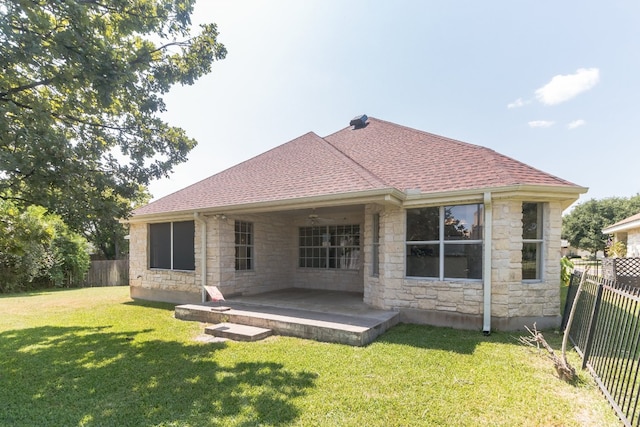 back of house featuring a lawn and a patio area