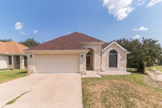 view of front of house with a front lawn and a garage