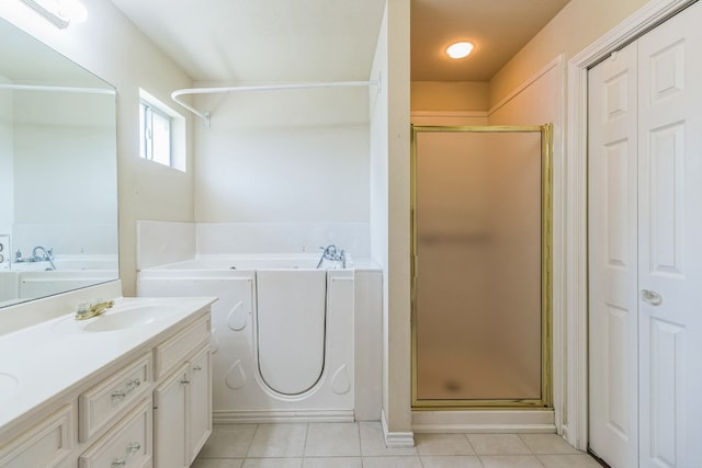 bathroom featuring vanity, shower with separate bathtub, and tile patterned floors