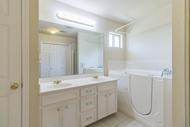 bathroom featuring vanity, shower with separate bathtub, and tile patterned floors