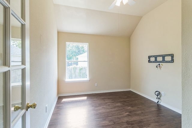 empty room featuring ceiling fan, dark hardwood / wood-style floors, and vaulted ceiling