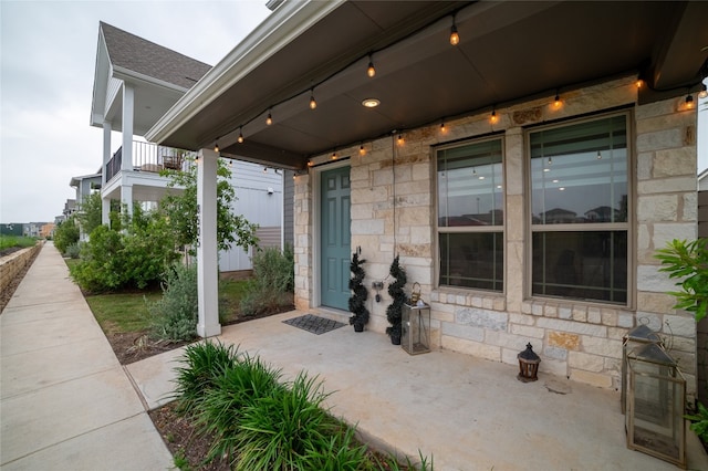 view of patio featuring a balcony