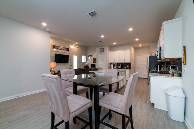 dining area featuring sink and light hardwood / wood-style floors