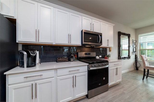 kitchen featuring white cabinetry, light hardwood / wood-style floors, and appliances with stainless steel finishes