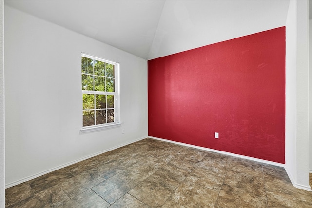 empty room featuring vaulted ceiling