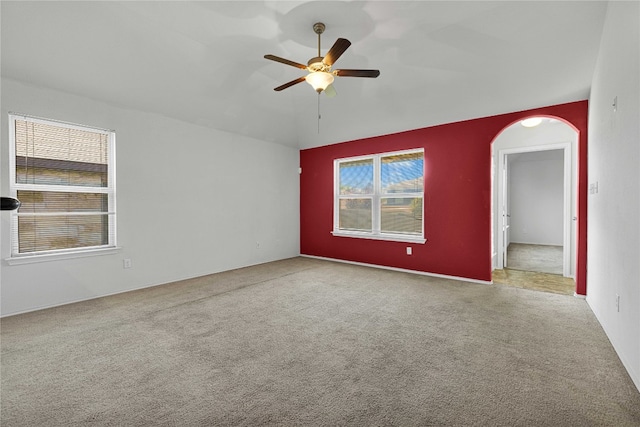 empty room featuring ceiling fan and light colored carpet