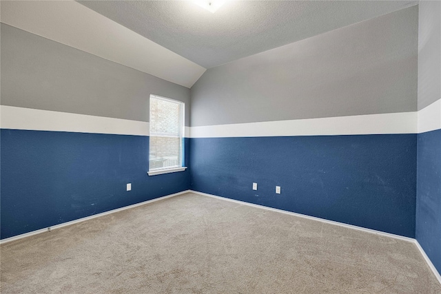 additional living space with carpet floors, a textured ceiling, and vaulted ceiling