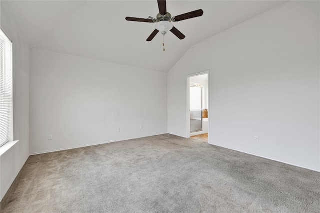 carpeted spare room with lofted ceiling, ceiling fan, and plenty of natural light