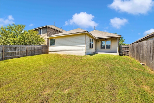 rear view of property with a lawn