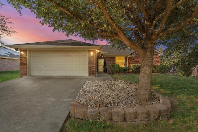 ranch-style home featuring a yard and a garage