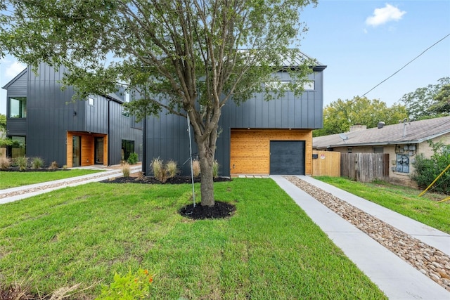 modern home featuring a front yard and a garage