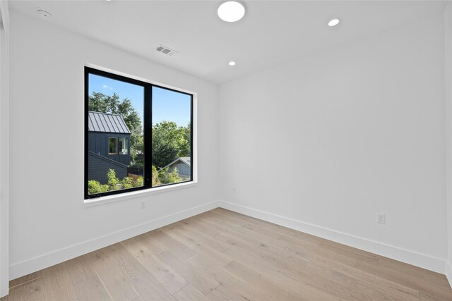 unfurnished room with light wood-type flooring