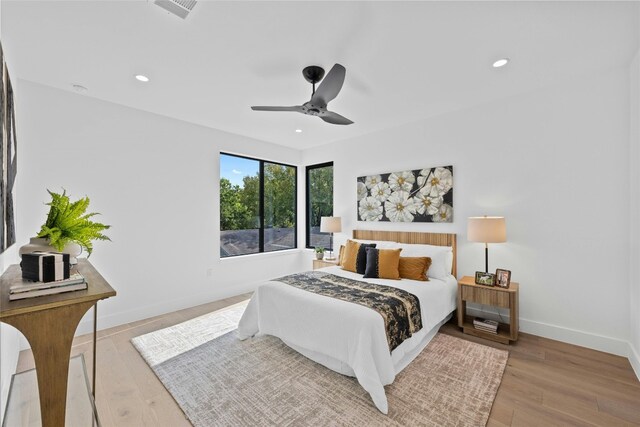 bedroom with light wood-type flooring and ceiling fan